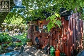 Hamilton (Eastmount) apartment for rent - A red wooden shed with gardening tools hanging on the wall.