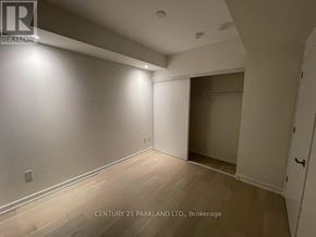 Toronto (Oakwood Village) condo for rent - A room with a wooden floor and white walls, with a door on the right side.