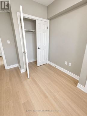 St. Catharines (Carlton/Bunting) duplex for rent - A room with a white door and a wooden floor.
