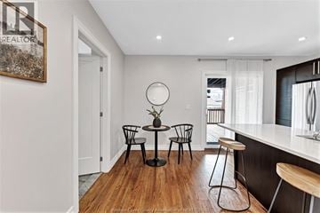 Windsor apartment for rent - A modern kitchen with a bar stool and a round table with four chairs.