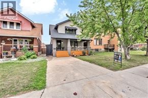 Windsor apartment for rent - A realtor photo of a house with a red brick building and a two-story house with a balcony.