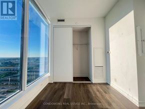 Vaughan (Vaughan Corporate Centre) condo for rent - A room with a large window and a view of the city.