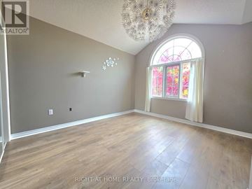 Richmond Hill (Oak Ridges) apartment for rent - A room with a large window and a chandelier.
