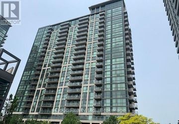 Mississauga (City Centre) condo for rent - A tall building with many windows and balconies is shown.