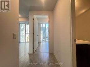 Toronto (Waterfront Communities) condo for rent - A hallway with a door leading to a balcony.