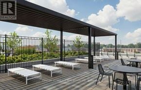 Milton (Tm Timberlea) condo for rent - A patio area with tables and chairs under a roof.