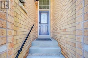 Oakville (Wc Wedgewood Creek) townhouse for rent - A blue door is at the end of a brick hallway.