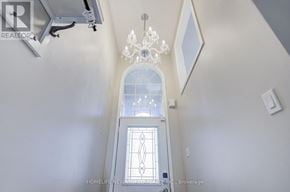 Oakville (Wc Wedgewood Creek) townhouse for rent - A chandelier hangs from the ceiling in a room with a window and a door.
