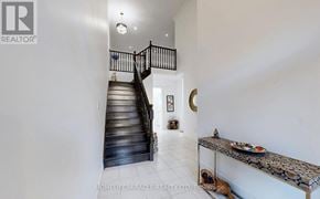 Guelph (Pineridge/Westminster Woods) townhouse for rent - A staircase with a black railing and wooden steps leads to a white room.