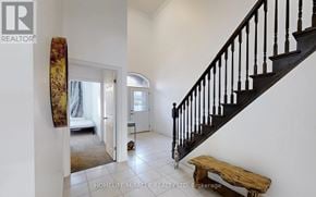 Guelph (Pineridge/Westminster Woods) townhouse for rent - A hallway with a staircase and a bench.