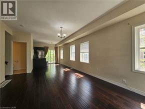Kitchener townhouse for rent - A long hallway with wood floors and windows on the side.