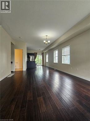 Kitchener townhouse for rent - A long hallway with wood floors and a white ceiling.