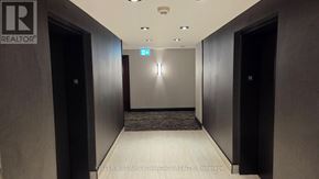 Mississauga (City Centre) condo for rent - A hallway with a brokerage sign on the wall.