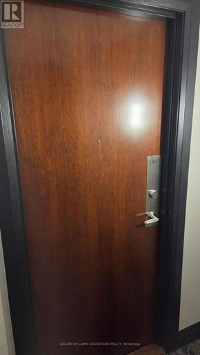 Mississauga (City Centre) condo for rent - A brown door with a silver handle and a number 1803 on it.