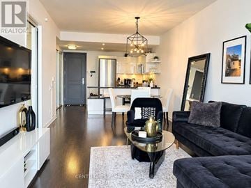 Toronto (Mimico) condo for rent - A modern living room with a black couch and a coffee table.