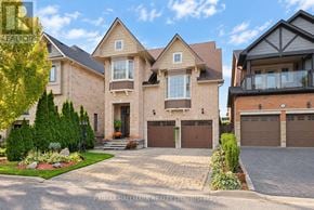Richmond Hill (Jefferson) apartment for rent - A large, well-maintained house with a driveway and garage doors.