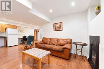 Richmond Hill (Jefferson) apartment for rent - A living room with a brown leather couch and a wooden coffee table.
