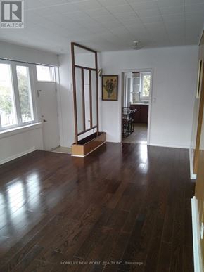 Toronto (Banbury-Don Mills) apartment for rent - A room with wooden floors and a large open doorway.