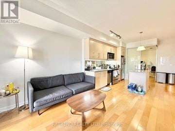 Toronto (Bayview Village) condo for rent - A living room with a grey couch and a wooden coffee table.
