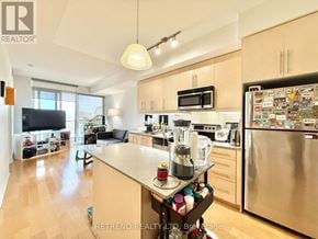 Toronto (Bayview Village) condo for rent - A kitchen with a refrigerator covered in magnets.