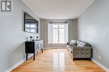 New Tecumseth (Alliston) apartment for rent - A living room with a grey couch and a black television.