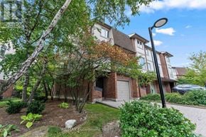 Mississauga (Clarkson) townhouse for rent - A residential building with a tree in front of it.