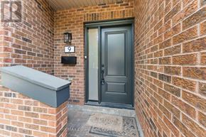 Mississauga (Clarkson) townhouse for rent - A brick wall with a door and a mailbox.