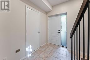 Mississauga (Clarkson) townhouse for rent - A hallway with a white door and a black railing.