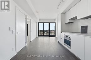Toronto (Thorncliffe Park) condo for rent - A spacious kitchen with white cabinets and a large window.