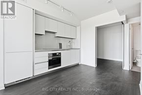 Toronto (Thorncliffe Park) condo for rent - A white kitchen with a refrigerator, oven, and cabinets.