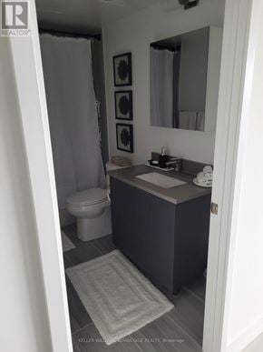 Toronto (Agincourt South-Malvern West) condo for rent - A bathroom with a toilet, sink and mirror.
