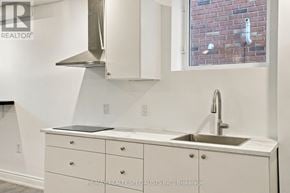 Milton (Cl Clarke) apartment for rent - A white kitchen with a sink and a window.