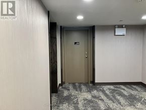 Blue Mountains townhouse for rent - A hallway with a closed door and a wall-mounted speaker.