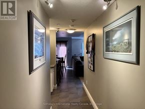 Blue Mountains townhouse for rent - A hallway with a painting on the wall and a couch in the background.