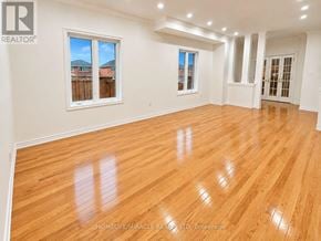 Whitby (Williamsburg) apartment for rent - A room with wooden flooring and white walls, with a window showing a view of a fence and houses.