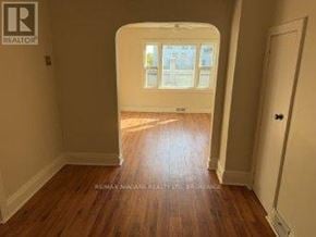 Fort Erie (Central) apartment for rent - A room with wooden floors and a doorway leading to another room.