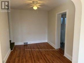 Fort Erie (Central) apartment for rent - A room with wooden flooring and a ceiling fan.