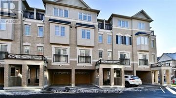 Oshawa (Windfields) townhouse for rent - A white car is parked in front of a building with a sign that says "REALTOR".