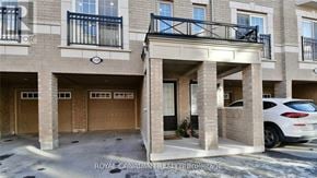 Oshawa (Windfields) townhouse for rent - A white car is parked in front of a building with a balcony.