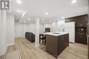 Mississauga (Churchill Meadows) townhouse for rent - A modern kitchen with brown cabinets and a white island.