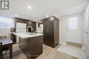Mississauga (Churchill Meadows) townhouse for rent - A modern kitchen with dark brown cabinets and a white countertop.
