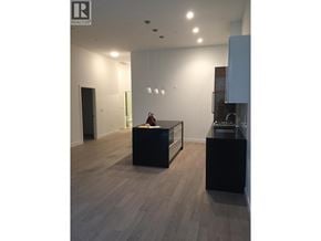 Vancouver apartment for rent - A realtor's office with a black desk and a cabinet.