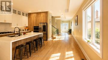 Mississauga (Port Credit) apartment for rent - A modern kitchen with wooden cabinets and a white countertop.