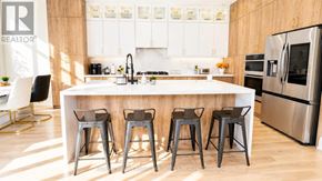 Mississauga (Port Credit) apartment for rent - A kitchen with a white island and bar stools.