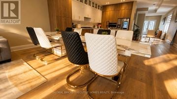 Mississauga (Port Credit) apartment for rent - A modern living room with a black and white chair in the center.