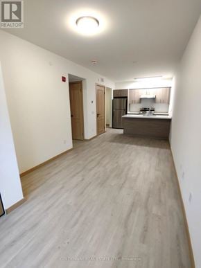 Toronto (L'amoreaux) townhouse for rent - A long, empty hallway with a kitchen area at the end.