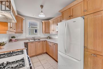 Hamilton (Hamilton Beach) apartment for rent - A kitchen with wooden cabinets and a white refrigerator.