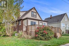 Hamilton (Hamilton Beach) apartment for rent - A house with a brown roof and a fence with red flowers in front.
