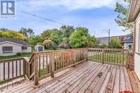 Hamilton (Hamilton Beach) apartment for rent - A wooden deck with a railing and a house in the background.