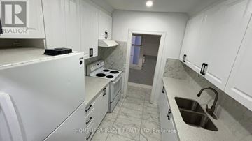 Brampton (Downtown Brampton) apartment for rent - A kitchen with white cabinets and a sink.